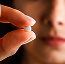 a person holding a pill