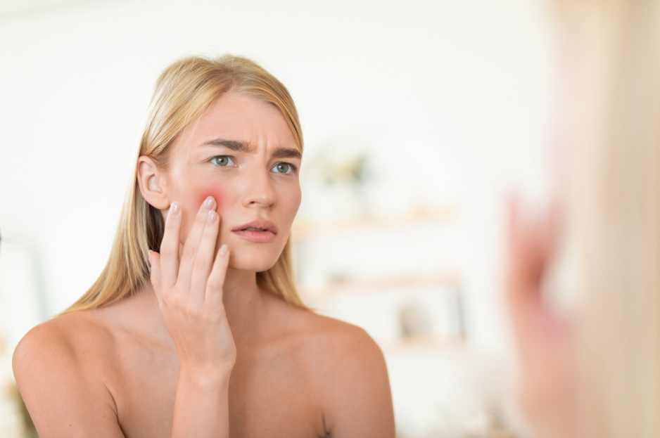 a woman looking at a mirror